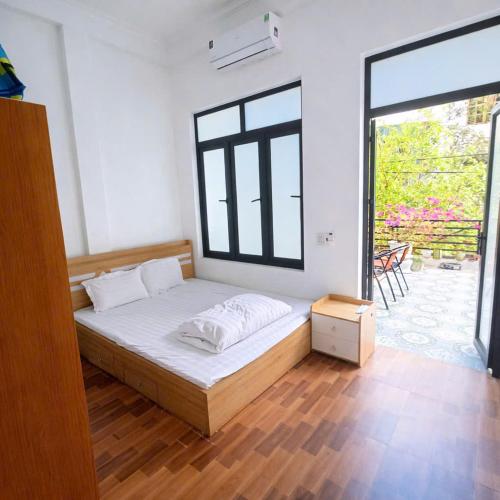 a bedroom with a bed and a large window at My Peaceful House Ninh Bình in Phúc Trì