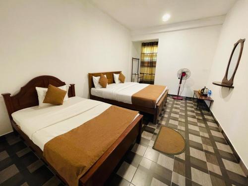 a hotel room with two beds in a room at Archwey Coco Ella in Ella