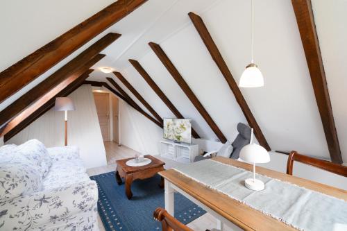 a living room with a couch and a table at Möhlenblick in Neustadt in Holstein