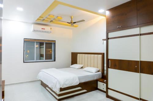 a bedroom with a bed and a window at Advik Resort in Badlapur