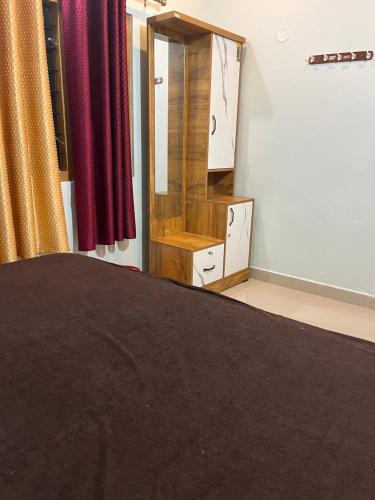 a dressing room with a mirror and red curtains at Morning Glory in Vagamon