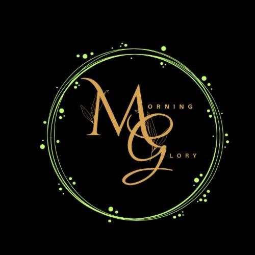 a gold logo with the letter m in a circle at Morning Glory in Vagamon
