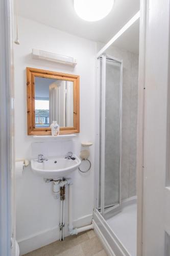 a white bathroom with a sink and a shower at Free Parking, Entire 8 Ensuite Bedroom Townhouse, Fully Equipped Kitchen, Dining Room & Lounge, Perfect for Family Gatherings, Long Term Contractor, Relocation, etc Stays, 15 mins to Nissan, 20 mins to Sunderland & Newcastle, See our Site for Assurance in South Shields