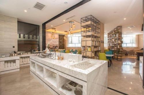 a large kitchen with a large marble counter in a room at Atour Hotel (Urumqi Renmin Cinema) in Ürümqi