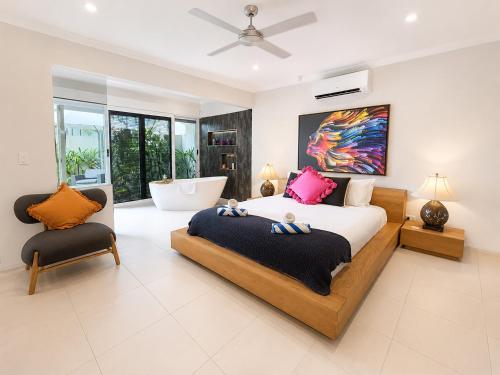 a bedroom with a king sized bed and a chair at Belle Escapes Chillandos in Smithfield
