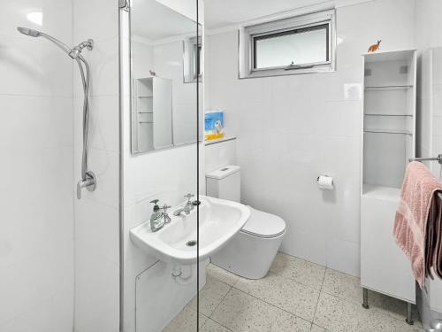 a white bathroom with a toilet and a sink at Right in Fremantle in Fremantle