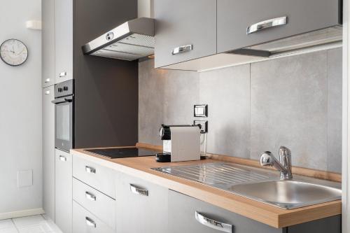a kitchen with a sink and a counter top at Bandiera Urban House in Lanciano