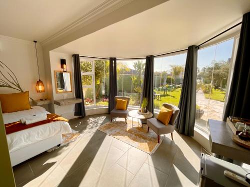 a bedroom with a bed and a large window at Olive Tree Boutique Guesthouse in Swakopmund
