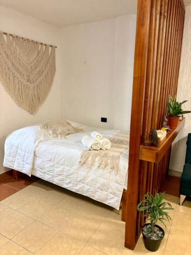 a bedroom with a bed with towels on it at Departamento chichan nah in Progreso