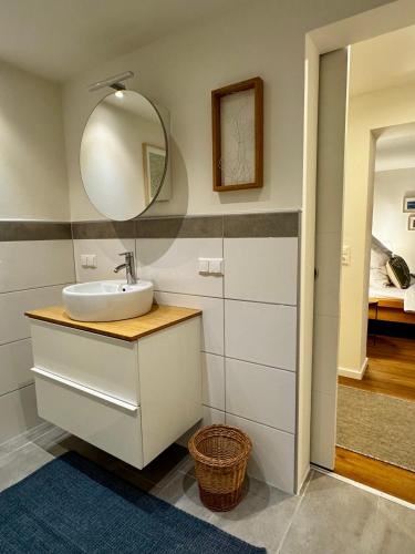 a bathroom with a sink and a mirror at Appartement Frieda in Seeboden