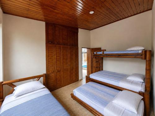 a room with three bunk beds in a house at Prima verde in La Serena