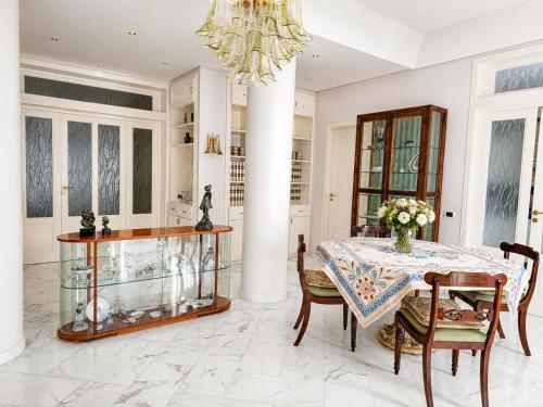 a dining room with a table and a chandelier at Avola Garden Apartment near Pantanello Beach in Avola