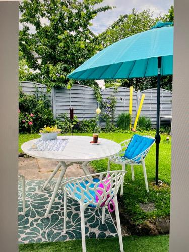 a table and two chairs under an umbrella at Ferienhaus Plan B. Wittlich in Wittlich
