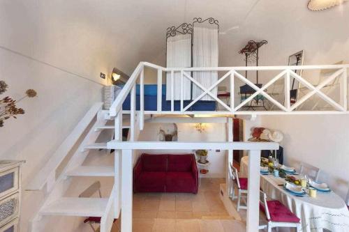 a room with a loft bed and a table at The Sirens House in Nerano