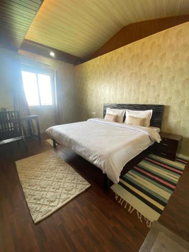 a bedroom with a large bed in a room at Stone Rose Vista in Kanatal