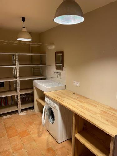 a kitchen with a washing machine and a sink at Château d'Arcamont in Roquelaure