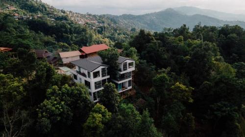 a large building in the middle of a forest at Mei Nai Home เมย นาย โฮม in Ban Sakat Nua