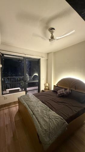 a bedroom with a large bed and a window at Ballentines Bliss in Babarpur