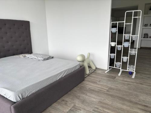 a bedroom with a bed and a wooden floor at Chaudeney in Chaudeney-sur-Moselle