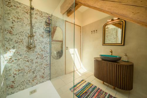 a bathroom with a sink and a glass shower at La maison des jours heureux in Leysse