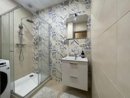 a bathroom with a shower and a sink and a tub at Modern flat in a city in Humenné