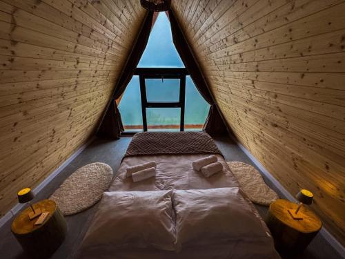 a room with a bed in a tent with a chair at Joy Chalet in Plaiu