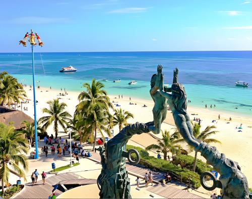 a statue of two people on a beach at Centro Mornings, King & 2BR Suites, Sleeps 2-8, Kitchen WiFi AC, Beach, 5th Ave, ADO & Ferry 4 Min in Playa del Carmen
