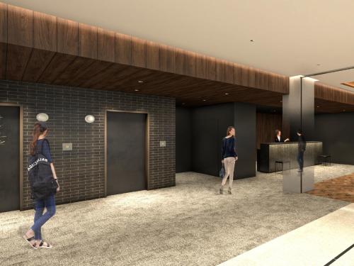 two women walking in a lobby with a counter at Nest hotel alt Sapporo Odori in Sapporo