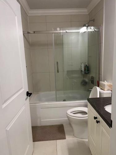 a bathroom with a shower and a toilet and a sink at 温哥华温西别墅民宿47 in Vancouver