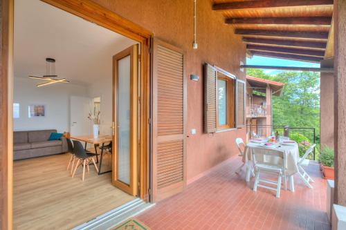 a living room and dining room with a table and chairs at Il Vecchio Faggio: Lake Maggiore view Terrace - Happy Rentals in Gignese