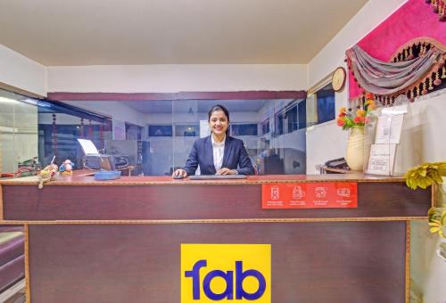 a man standing behind a counter in an office at FabHotel Sun Mint - Jubilee Hills in Hyderabad