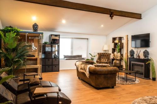 a living room with a couch and a fireplace at Wellness Suite mit Whirlpool und Sauna in Ahlen
