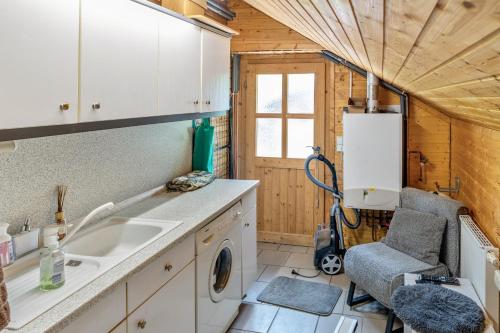 a kitchen with a sink and a washing machine at Ferienhaus Obert - Drognitz in Drognitz