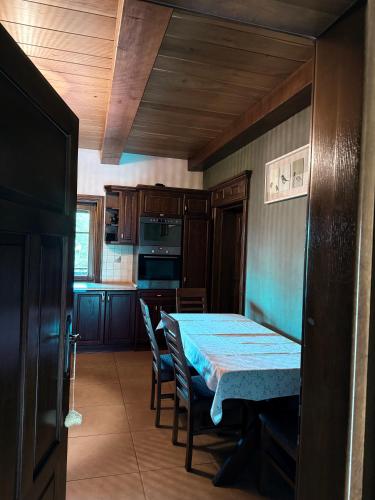 a kitchen with a table and chairs and a table and a kitchen at Hubertówka Dom in Ujanowice