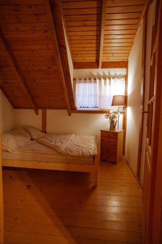 a bedroom with a bunk bed and a window at DOMKI POD JARZĘBINĄ in Puck