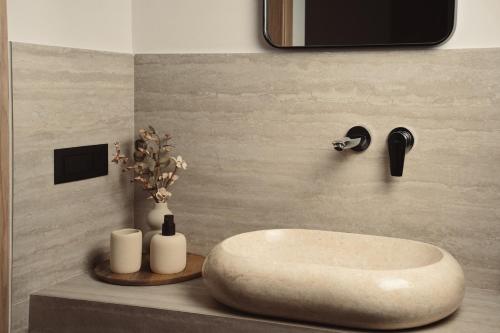 a bathroom with a white sink on a counter at Orien, Seaside Luxury Villa in Argassi