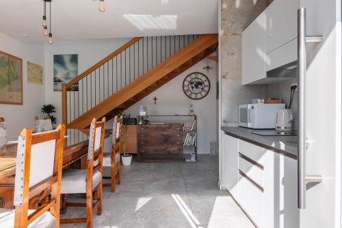 a kitchen and dining room with a staircase in a house at Agriturismo da Natalino in Ceggia