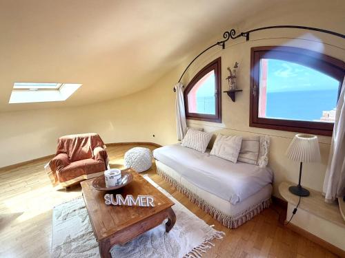a living room with a couch and a table at Villa Soprana by Agenzia SolturElba in Capoliveri