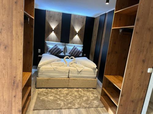 a bedroom with a large bed with wooden walls at Apartmenthaus Zeuthen 1 in Zeuthen