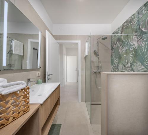 a bathroom with a shower and a sink at Desamani 975 in Kostrena