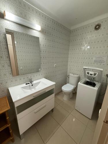 a bathroom with a sink and a toilet and a mirror at AwayDays - Apartamento en la 7a planta vista mar! in Empuriabrava