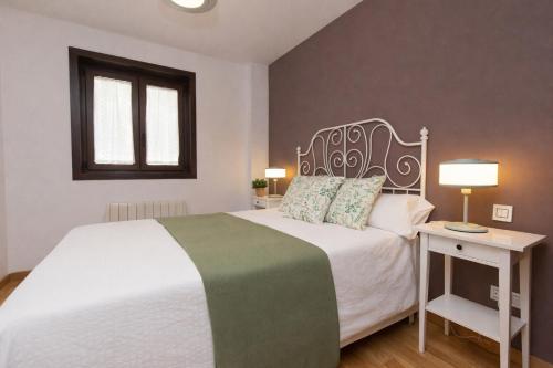 a bedroom with a white bed and a window at Casa MiMar by BeValle in Panticosa