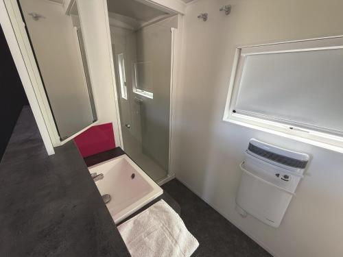 a small bathroom with a sink and a window at CAMPING PANORAMIQUE du VERDON in Castellane