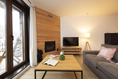 a living room with a couch and a table at Acentor Alpino by BeValle in Panticosa