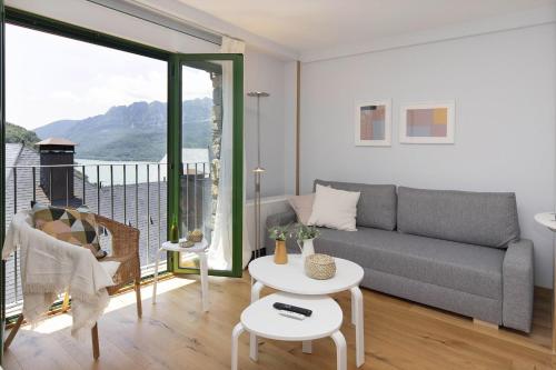 a living room with a couch and a table at Ripereta by BeValle in Panticosa