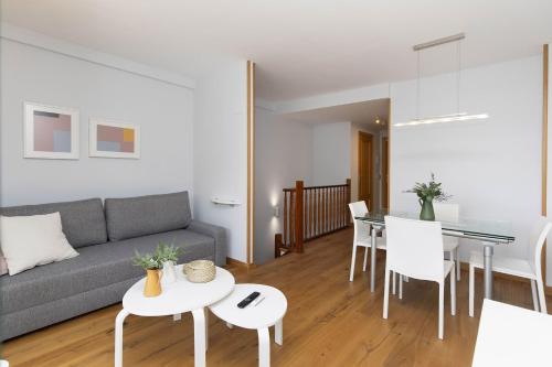 a living room with a couch and a table at Ripereta by BeValle in Panticosa