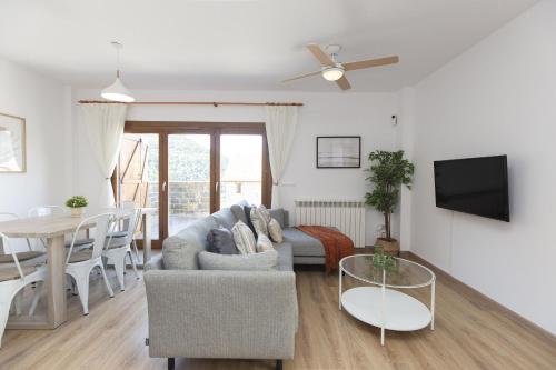 a living room with a couch and a table at Aura de Gavin by BeValle in Buesa