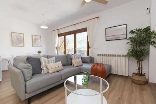 a living room with a couch and a glass table at Aura de Gavin by BeValle in Buesa