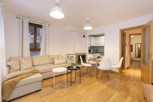 a living room with a couch and a table and chairs at Calma by BeValle in Panticosa