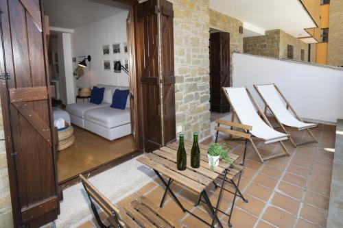 a living room with a table and chairs and a couch at PanticAsa Azul by BeValle in Panticosa